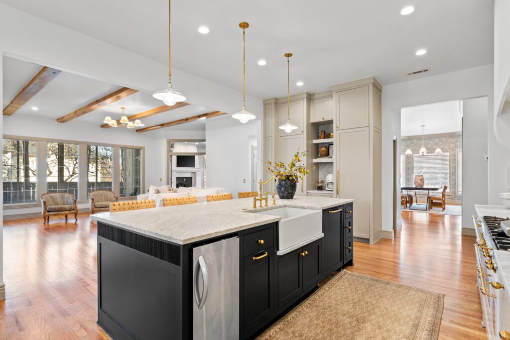 Custom kitchen renovation with a farmhouse sink island and wood ceiling beams by J&E Home Remodeling