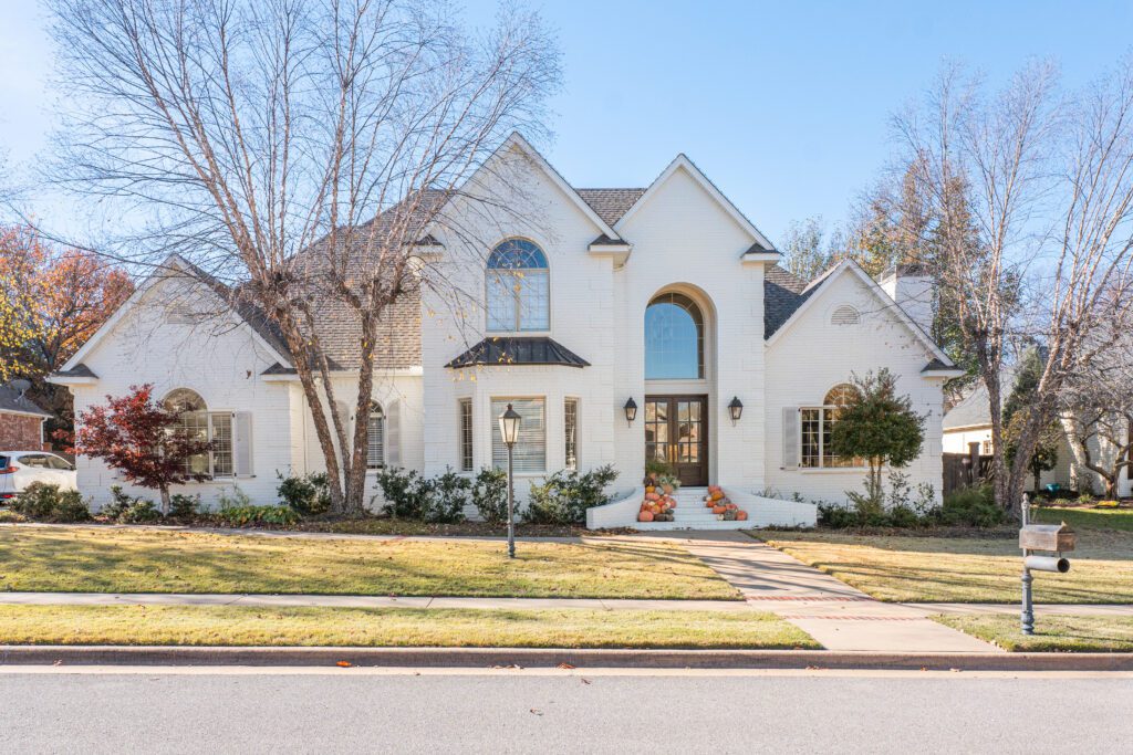 White brick two-story home remodeled by J&E Home Remodeling in Rogers, AR