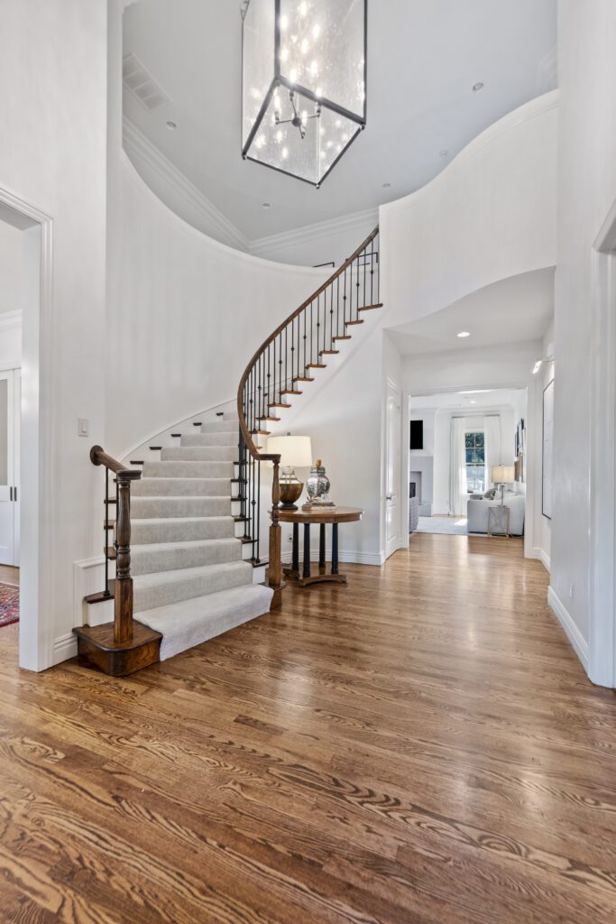 Curved staircase and two-story foyer remodeled by J&E Home Remodeling in Rogers, AR